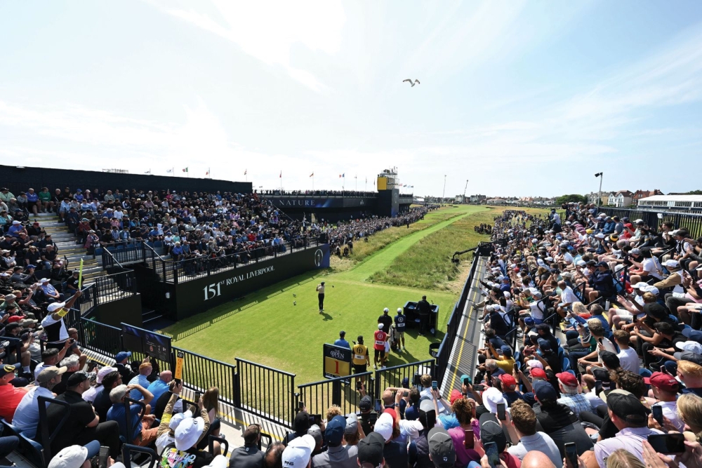 Rory McIlroy at the heart of a great photo showing the first tee arena with the sun shining and stand full to capacity with 800 fans anticipating a great day’s golf. See how narrow the first fairway looks - no wonder only a third of the players hit it!