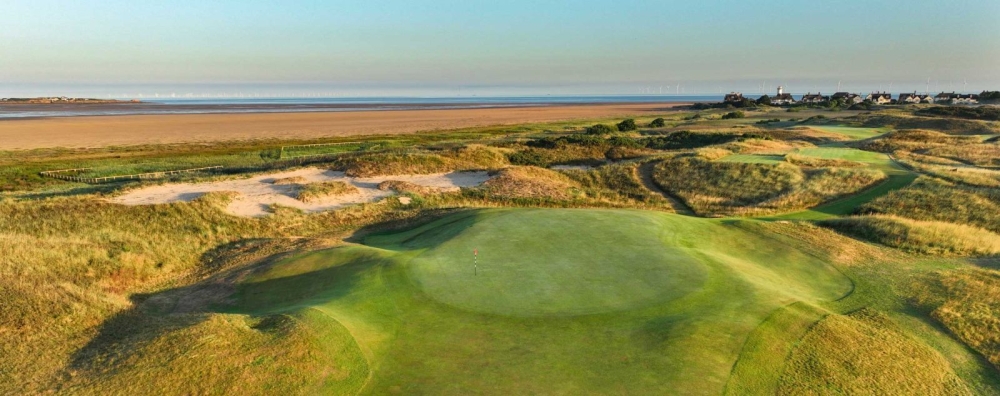 A dog leg to the left which invariably plays longer than its yardage, 'Dee' is a demanding par 4. It’s tempting to take off some of the dog-leg when you are faced with three bunkers on the right of the fairway, but the broken ground in the rough on the left makes that dangerous.